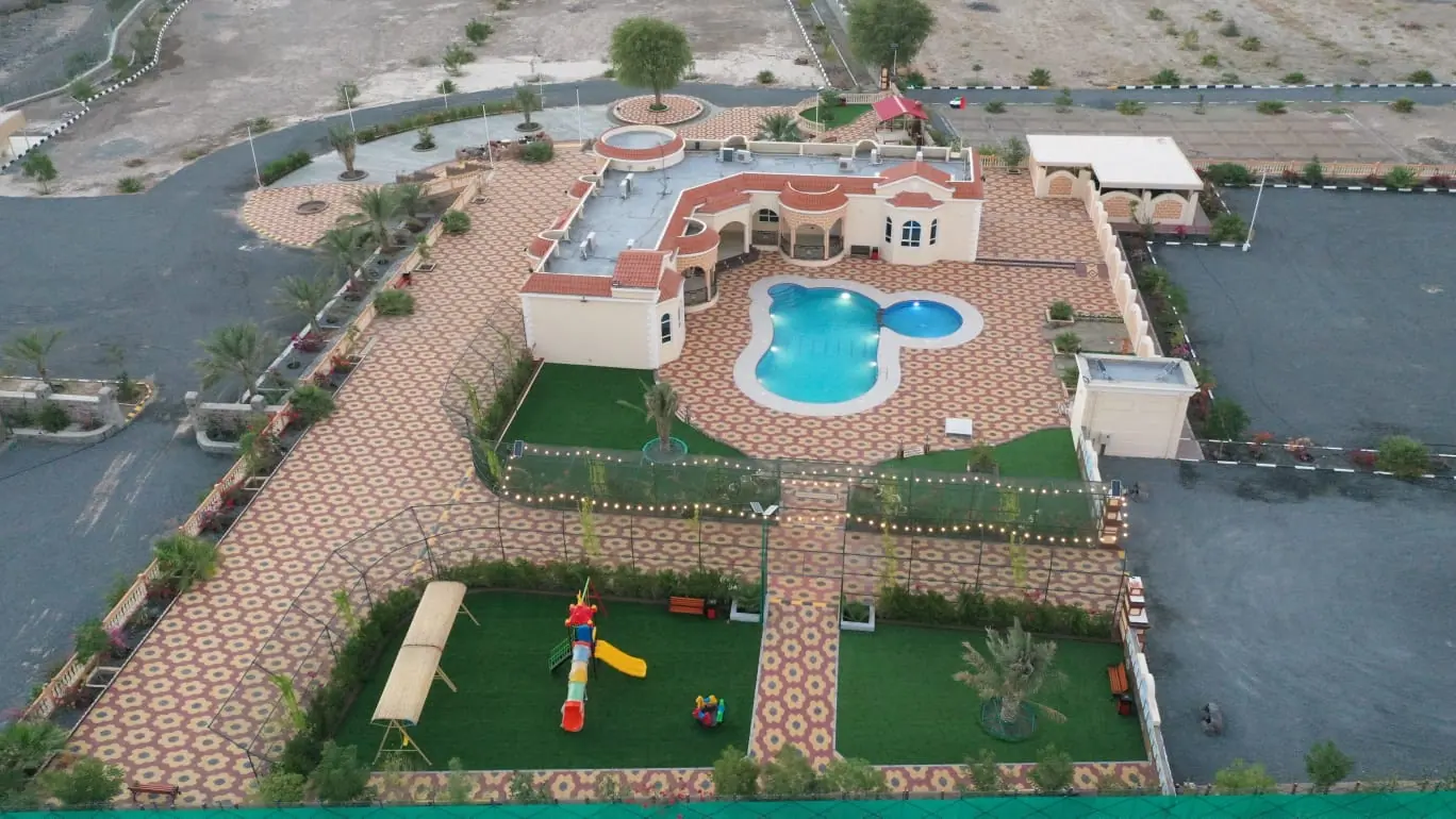 Aerial view of Mountain Resort farmhouse, pool and gardens in Wadi Sfani