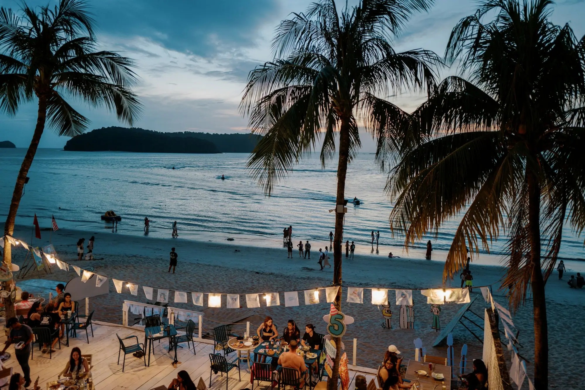 Palm trees and a sandy beach on Langkawi in the evening